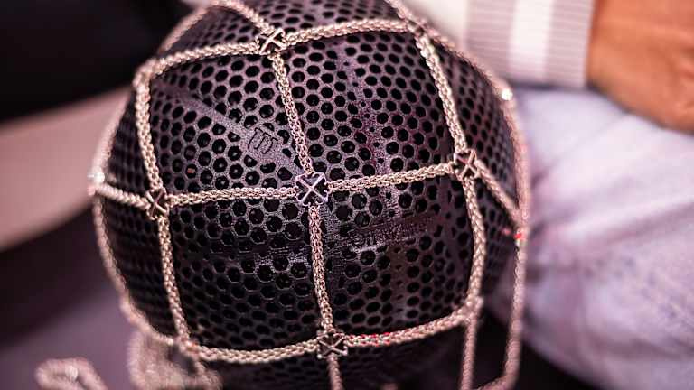 Sabalenka's courtside accessories included Wilson's Airless Gen1 basketball in an Off-White chain net bag.