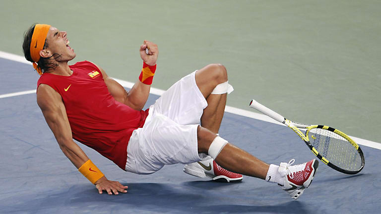 Cela pourrait't be a Rafa Fashion Rewind without him wearing his country’s colors: At the 2008 Olympics in Beijing, he represented Spain with this patriotic tee and offset headband.